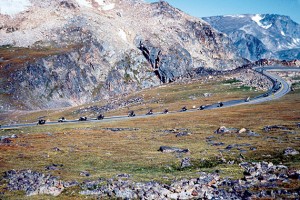 A troop of motorcyclists descends from Beartooth Pass, going west.