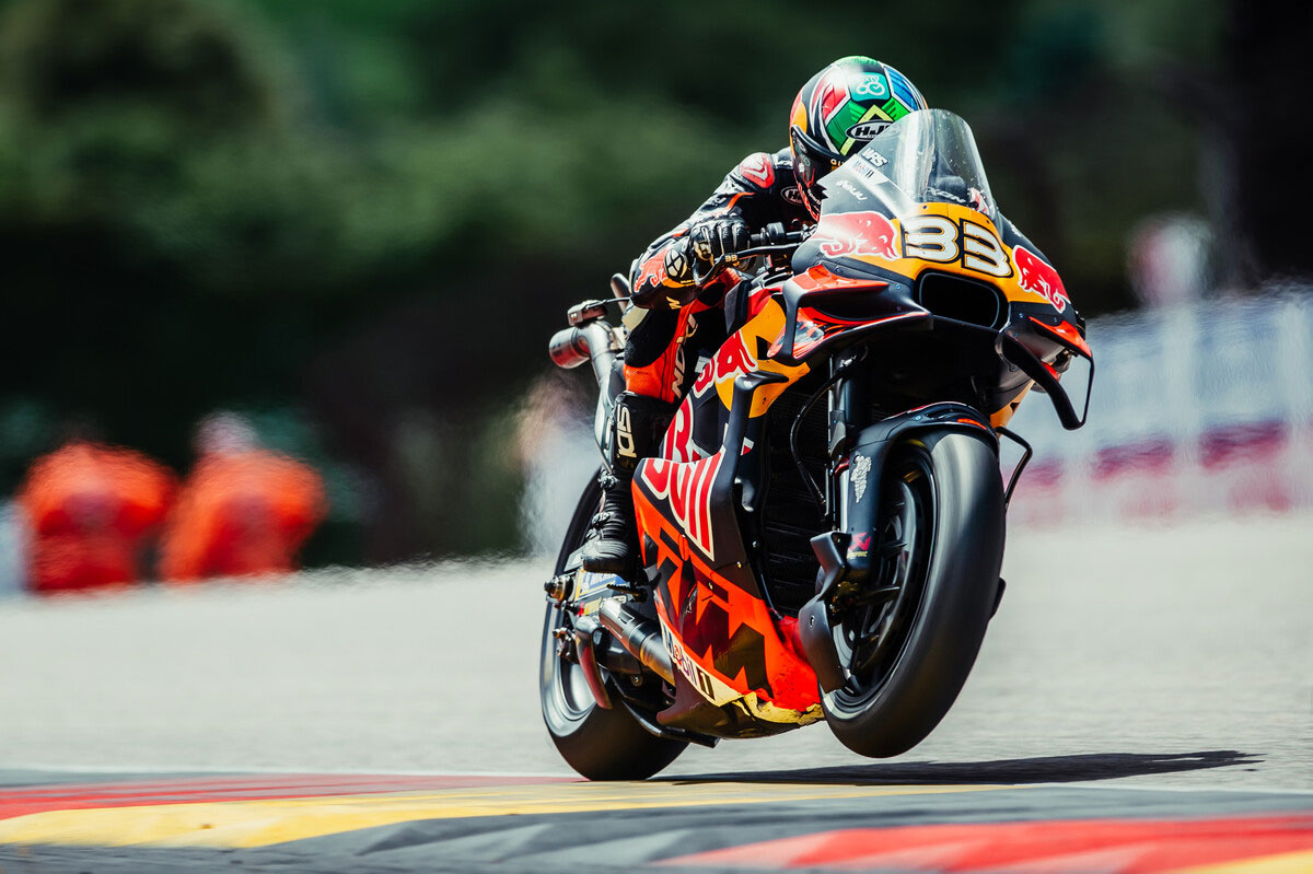 Brad Binder racing at high speed on KTM bike #33 during the 2025 MotoGP German Grand Prix at Sachsenring.