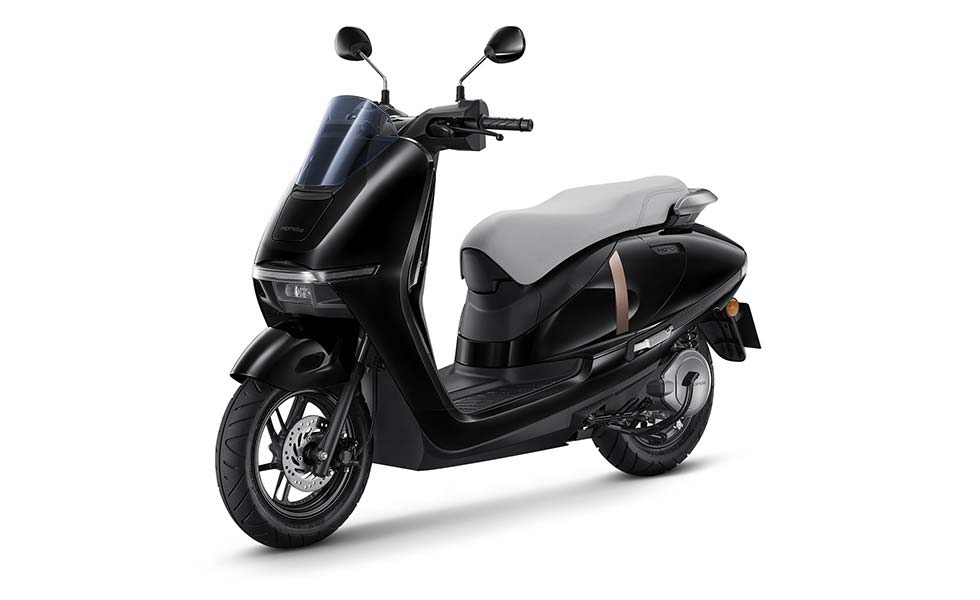 Honda UC3 electric two-wheeled commuter in black shown from front left three-quarter view