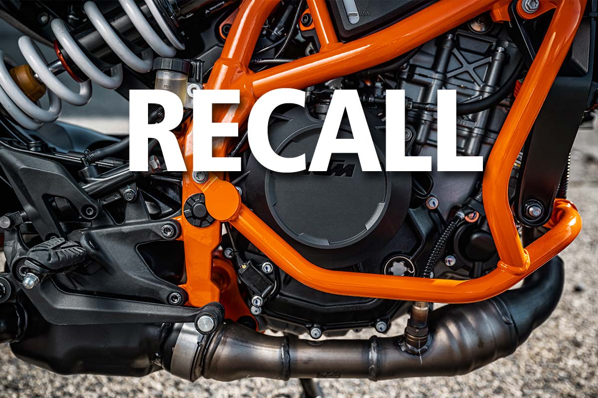 Close-up of KTM motorcycle with recall notice related to ECU software update
