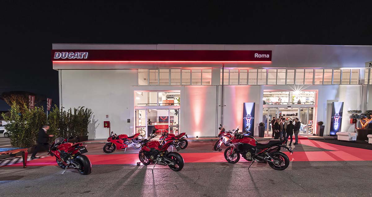 Ducati Roma dealership exterior with motorcycles at night