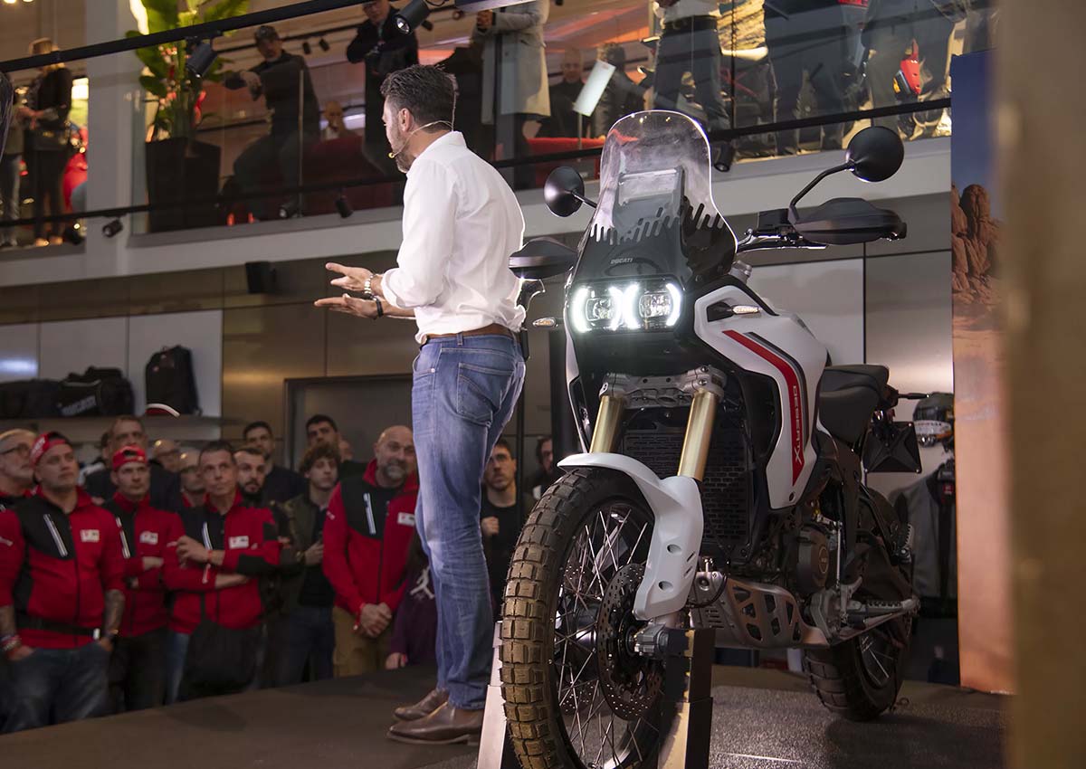 Presenter showcasing Ducati DesertX at launch event